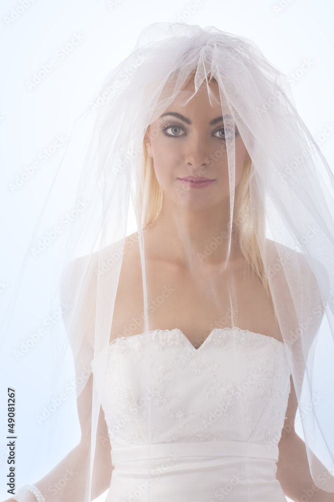 bride with veil on the face in front of the camera bride with veil on the face in front of the camera