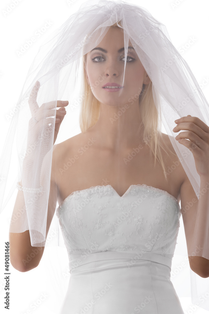 Fototapeta premium bride with veil on the face looks in to the lens