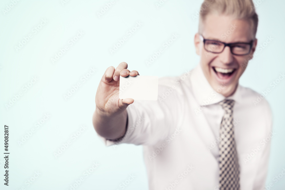 Overjoyed businessman showing white empty card. Overjoyed businessman showing white empty card.