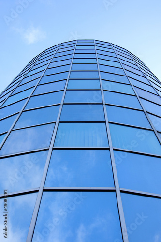 round facade of office building with blue reflected