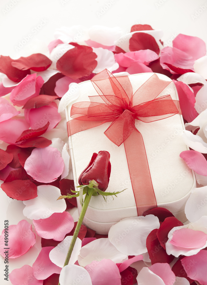 Valentines Day gift in red box with rose petal Valentines Day gift in red box with rose petal
