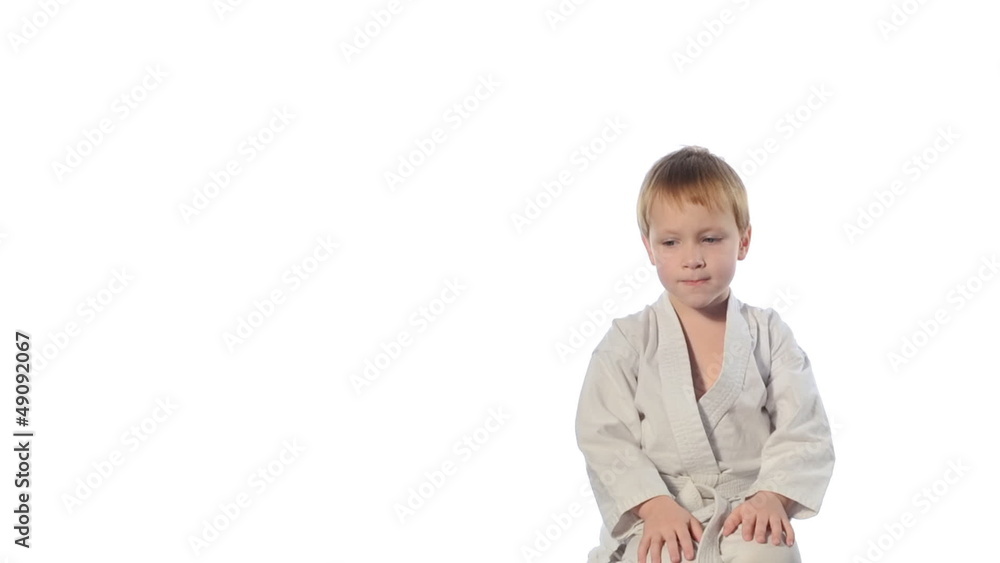 Karate boy exercising isolated against white background Karate boy exercising isolated against white background