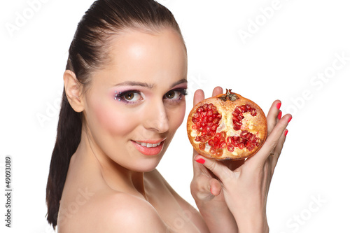 Beautiful young woman with a pomegranate.