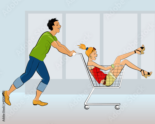 A guy pushing a shopping cart with a girl in it