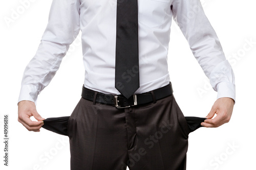 Broke business man with empty pockets, isolated on white