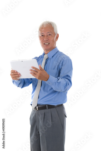 south east asian chinese senior holding a tablet surfing