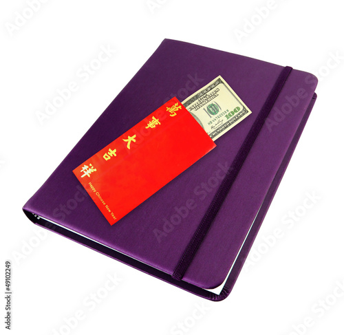 Money dollar cash in red envelope on purple notebook photo