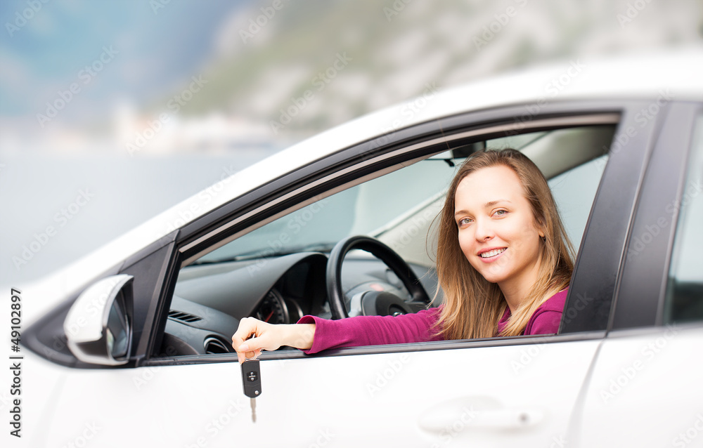 Woman with keys of new rental car