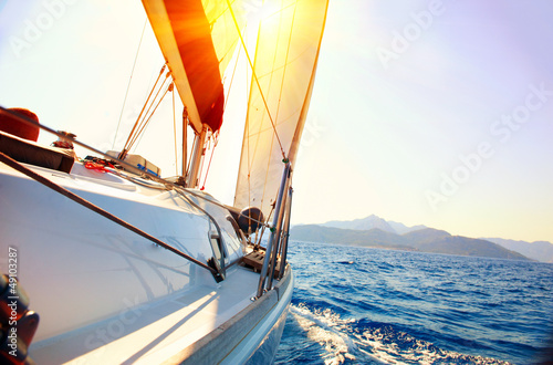 Obraz na plátně Yacht Sailing against sunset. Sailboat. Yachting. Sailing