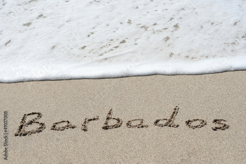 Conceptual handwritten text Barbados in sand