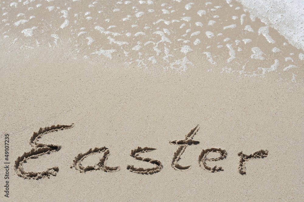Fototapeta premium Conceptual handwritten text Easter in sand
