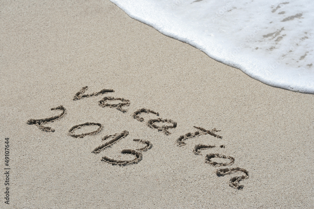 Fototapeta premium Conceptual handwritten 2013 year text in sand