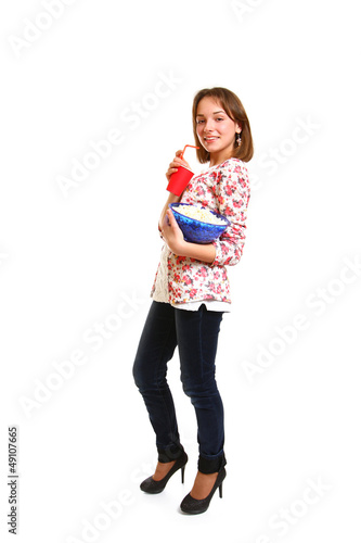Smiling girl with popcorn and a cup isolated on white background