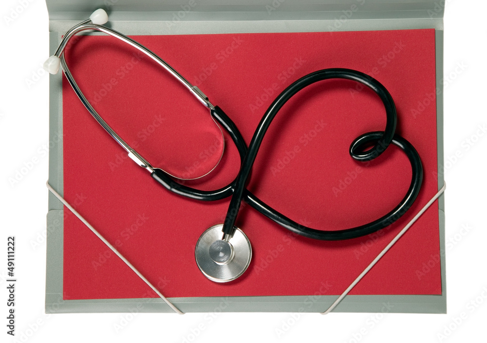 Stethoscope with heart shape is lying on paper Stethoscope with heart shape is lying on paper