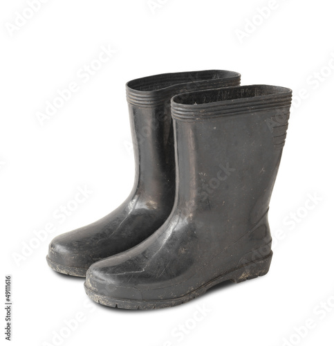 Dirty rubber boots isolated on white background