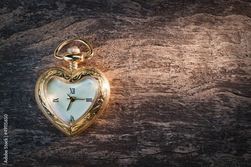 Antique gold pocket watch in the form of heart.