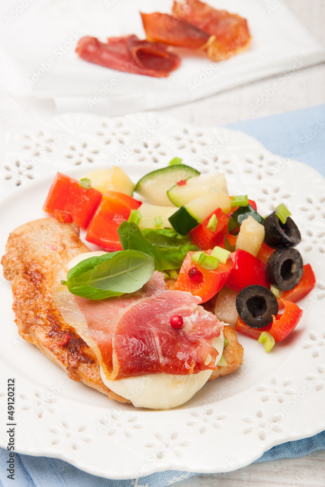 chicken fillet baked with mozzarella, Parma ham and vegetables