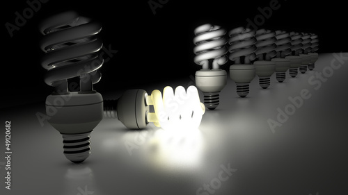 Quadro su tela Compact fluorescent lamps in a row. One is enlightening.