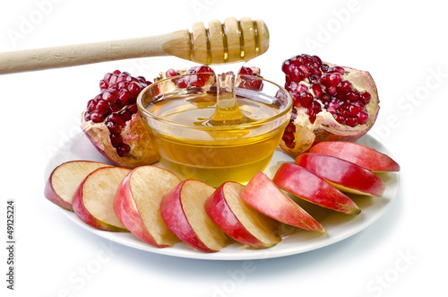 Photo Cut into slices of apples, pomegranate and honey