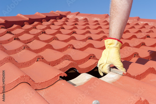 Construction worker shingle roofing repair