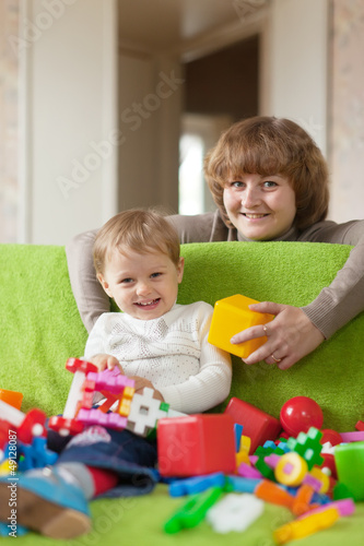 Happy mother plays with child