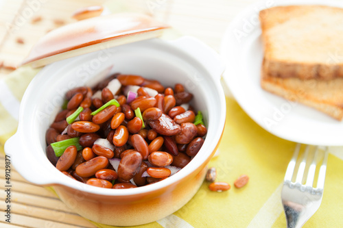 brown beans with onion in a ceramic pot