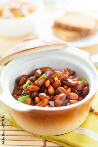 beans in a ceramic pot on a napkin