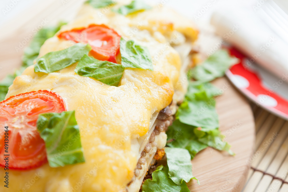 Vegetable lasagna with tomato on top Vegetable lasagna with tomato on top