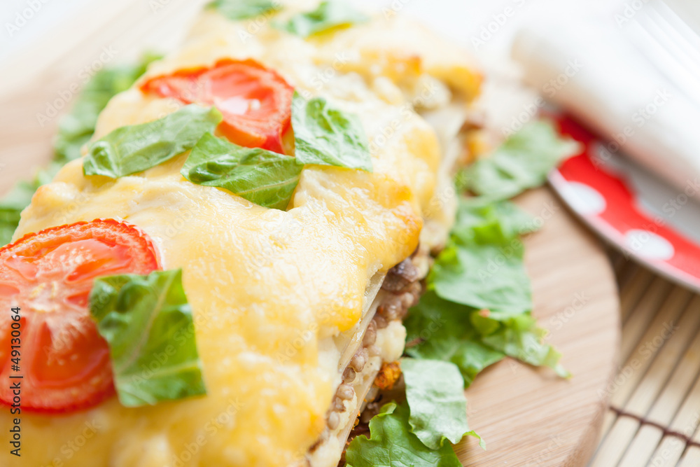 Vegetable lasagna with tomato on top