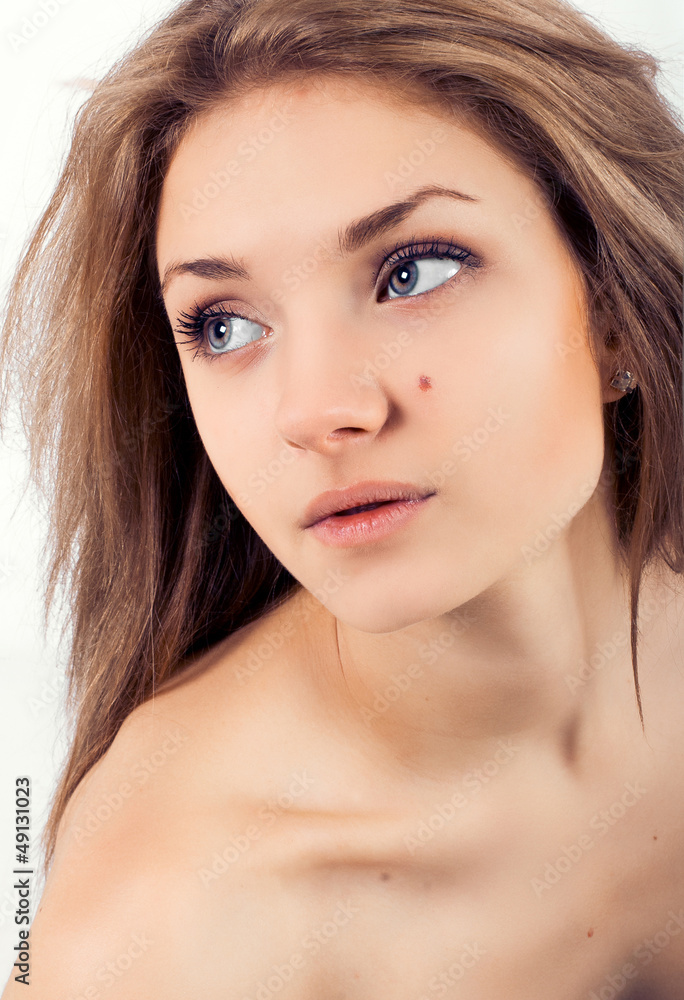 Attractive beautiful young girl on a white background Attractive beautiful young girl on a white background
