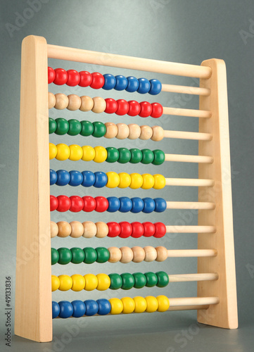 Bright wooden toy abacus  on grey background