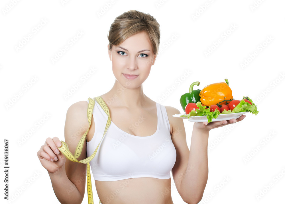 The beautiful girl with a plate with vegetables The beautiful girl with a plate with vegetables