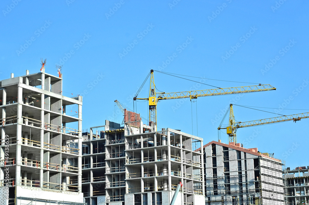 Crane and building construction site against blue sky Crane and building construction site against blue sky