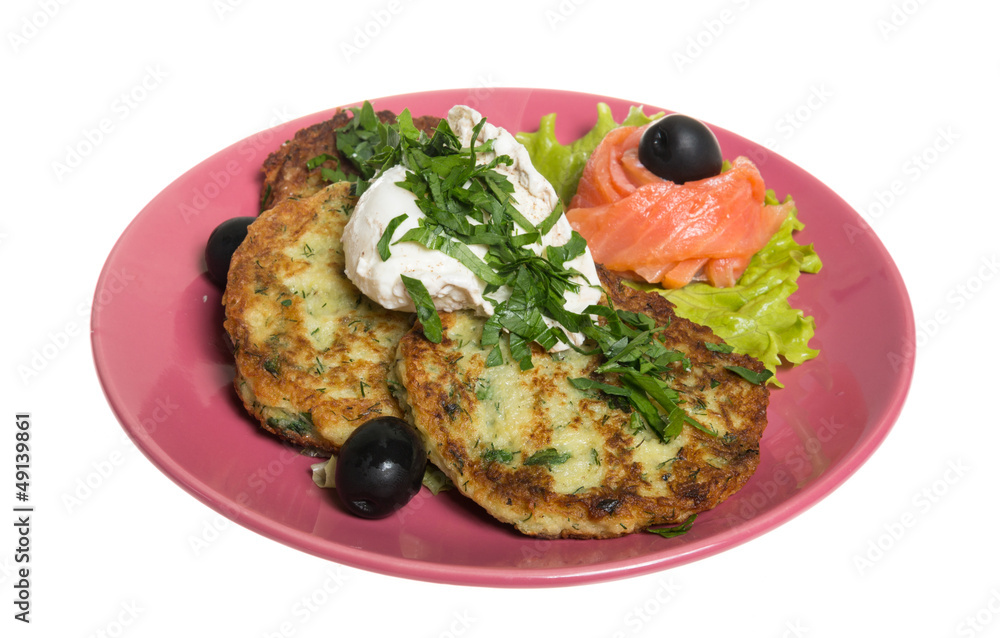 Roasted cutlets of potato with salmon on a plate