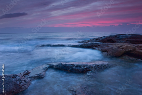 Sunrise over the rocky seashore © niki spasov