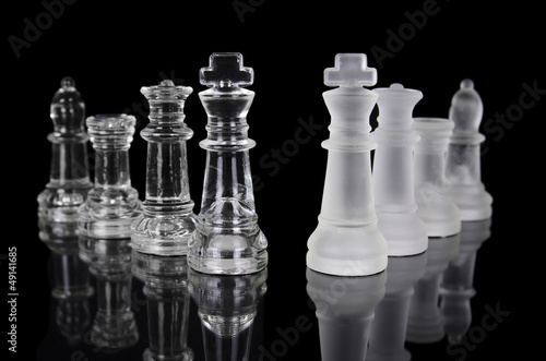 Chess pieces isolated on black background.