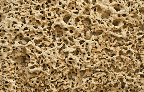 Texture of pitted ancient stone surface.