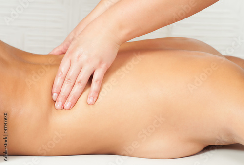 Young women getting back massage in massage salon