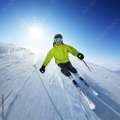 Skier on piste in high mountains