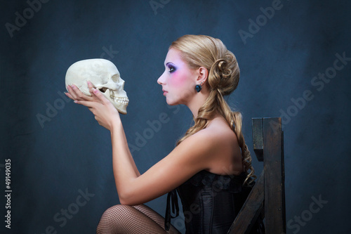 Woman with a skull, studio shot