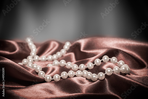 Pearls on a silk fabric background