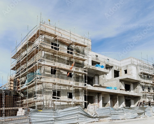 Three-storeyed apartment building under construction photo