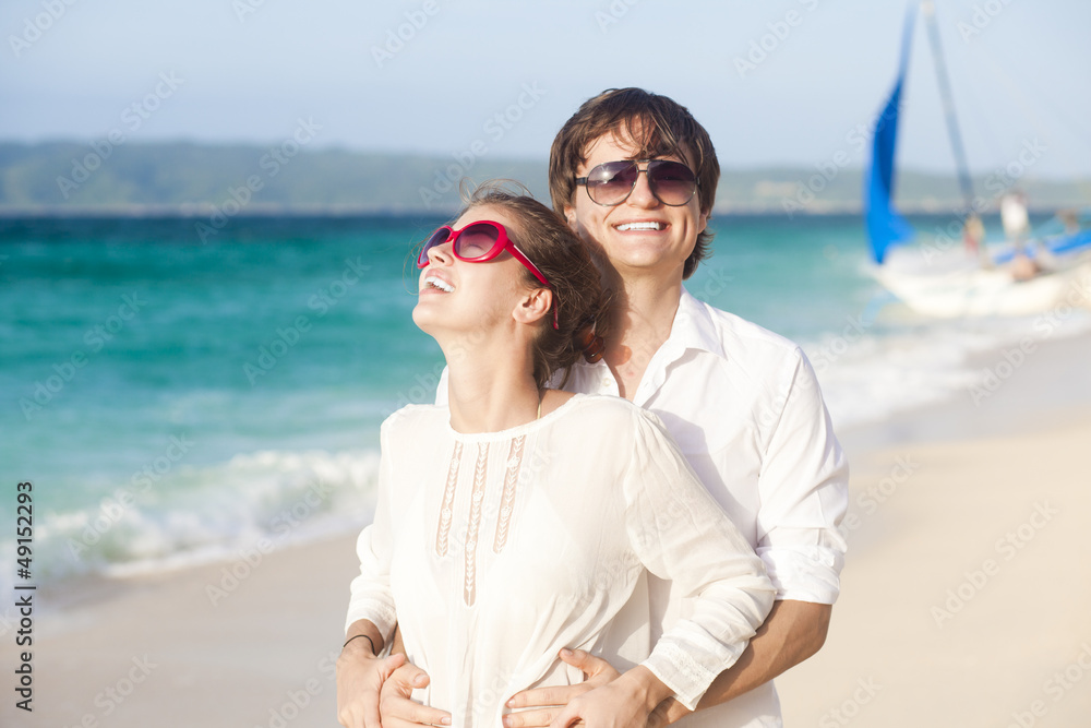 young happy couple having fun on tropical beach. honeymoon young happy couple having fun on tropical beach. honeymoon