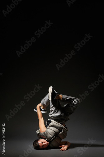 hip-hop dancer posing over dark