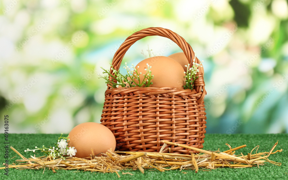 Eggs in basket on grass on natural background Eggs in basket on grass on natural background