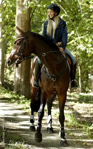 Young woman horse riding in the forest © nyul