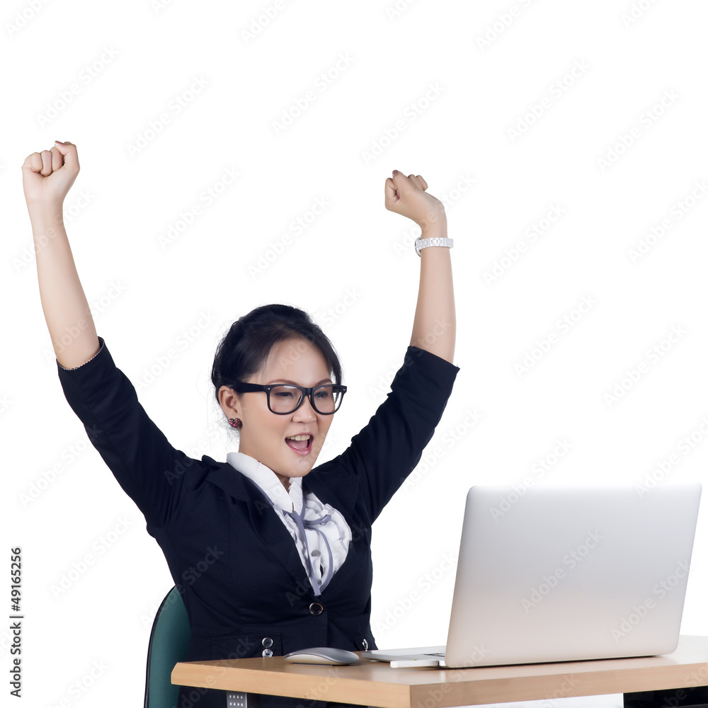 Happy business woman working on a laptop at the office Happy business woman working on a laptop at the office