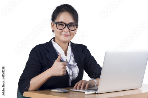 Portrait of confident business woman sitting at the table and wo