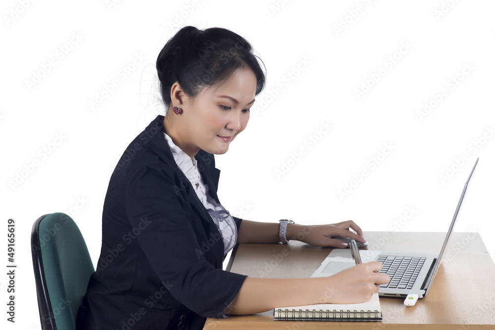 Portrait of confident business woman sitting at the table and wo Portrait of confident business woman sitting at the table and wo
