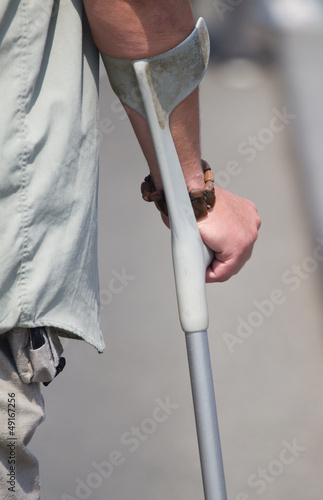 Male holding a crutch Fototapeta